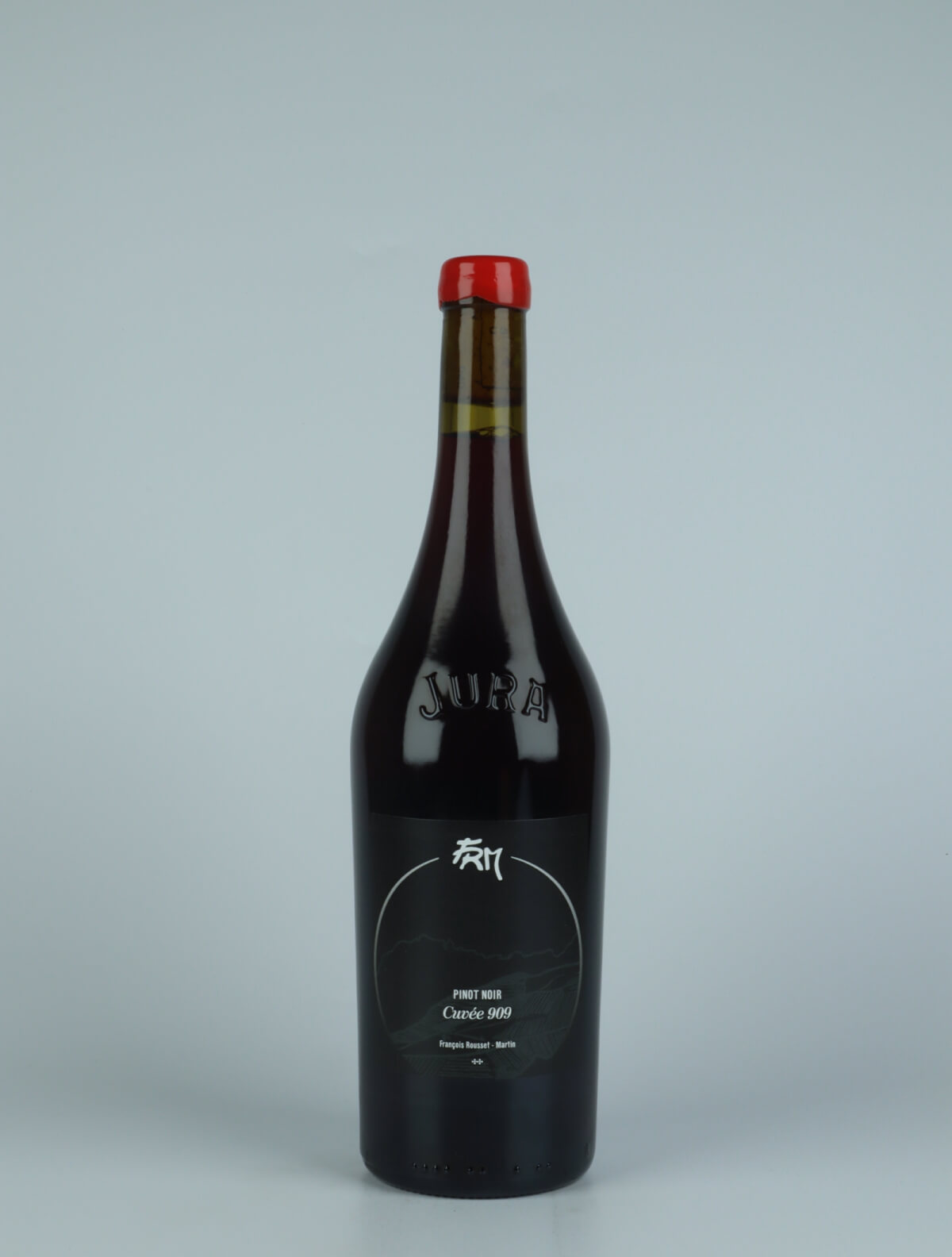 A bottle 2018 Cuvée 909 - Pinot Noir Red wine from François Rousset-Martin, Jura in France