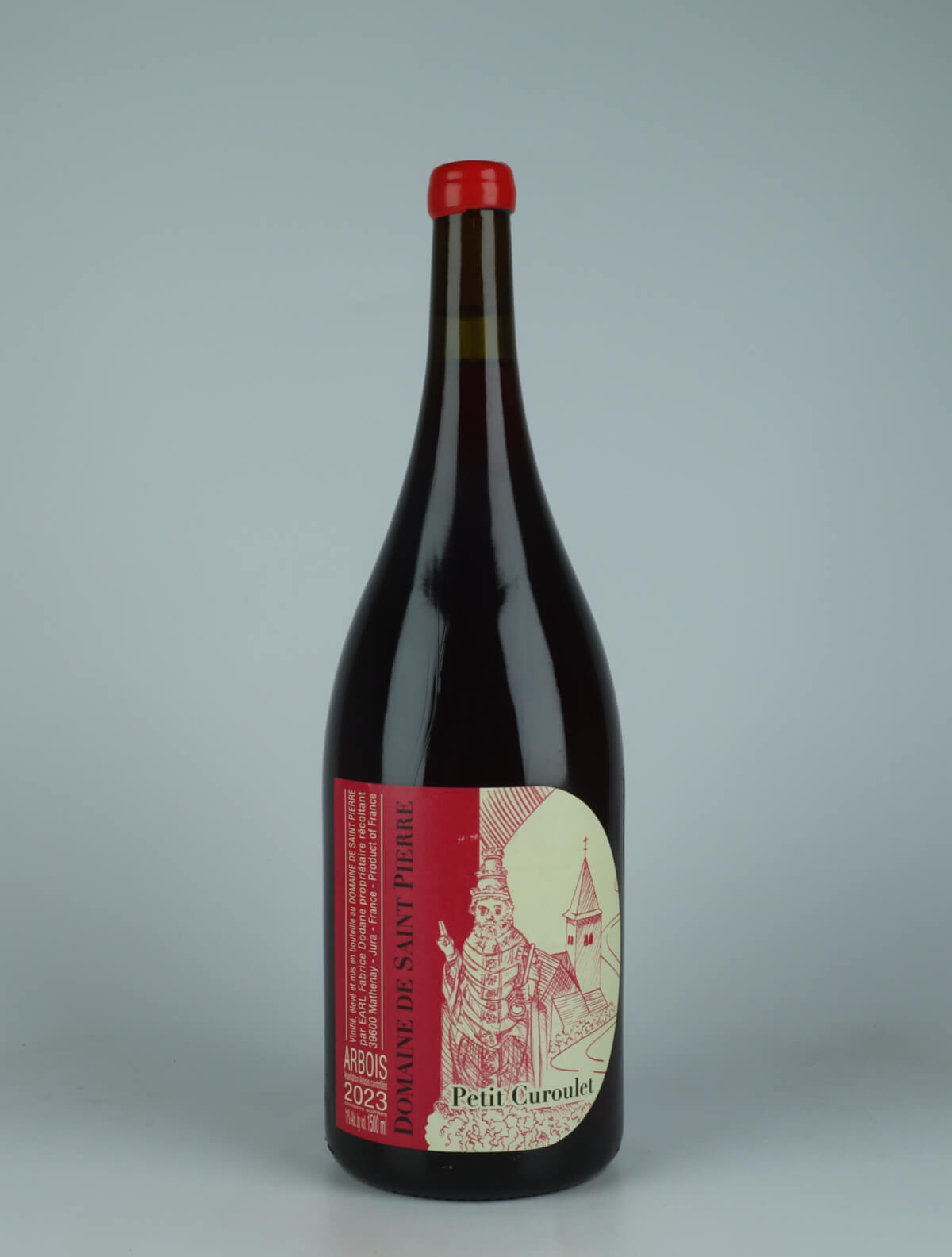 A bottle 2023 Arbois Rouge - Petit Curoulet - Magnum Rødvin from Domaine de Saint Pierre, Jura in Frankrig