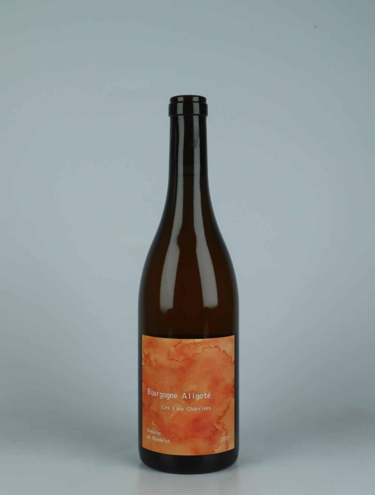 A bottle 2023 Bourgogne Aligoté - Macération - Les Eaux Charriées Orange wine from Domaine de Mandelot, Burgundy in France