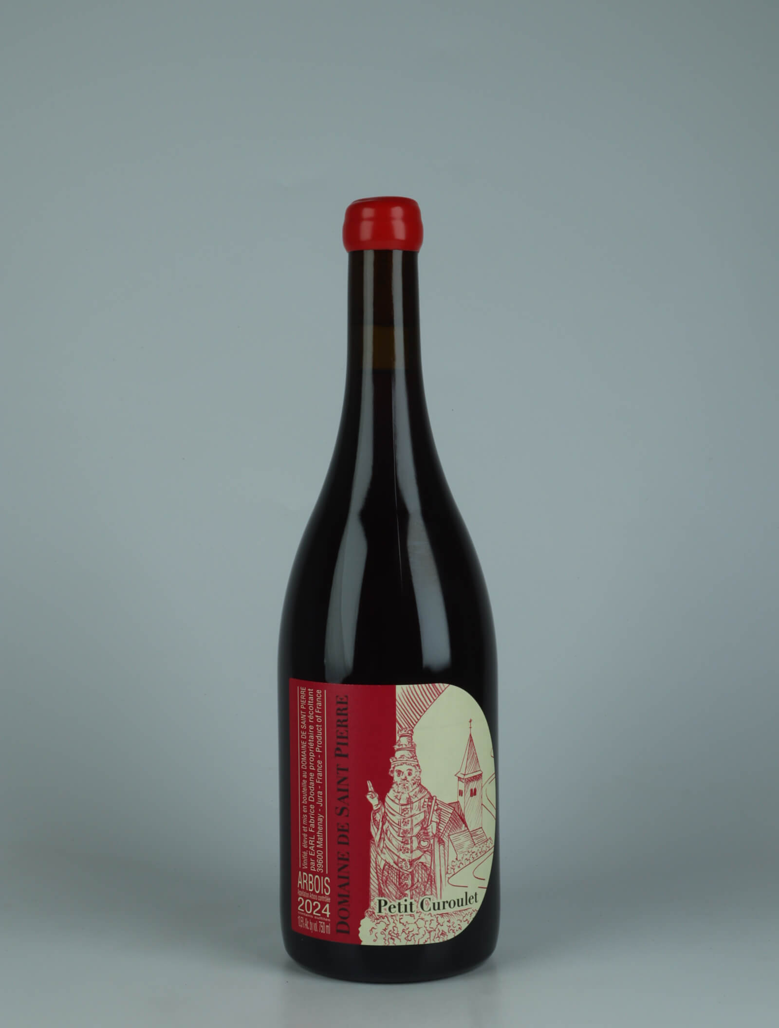 A bottle 2024 Arbois Rouge - Petit Curoulet Rødvin from Domaine de Saint Pierre, Jura in Frankrig