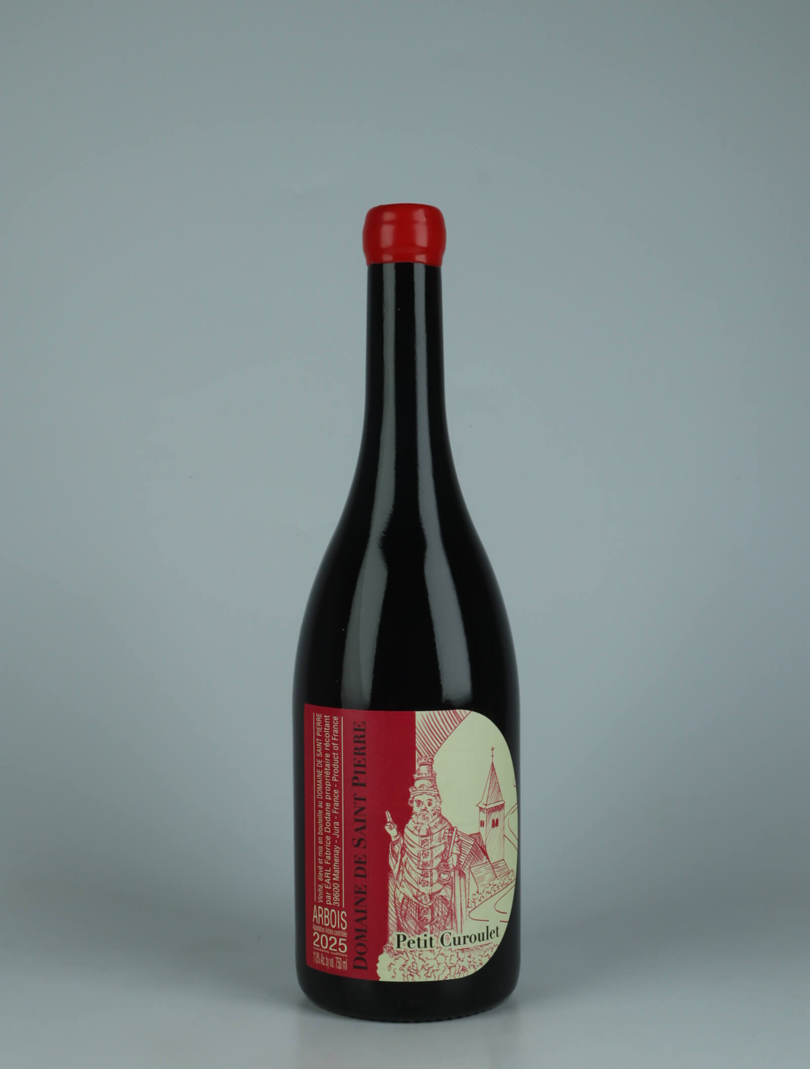 A bottle 2025 Arbois Rouge - Petit Curoulet Rødvin from Domaine de Saint Pierre, Jura in Frankrig