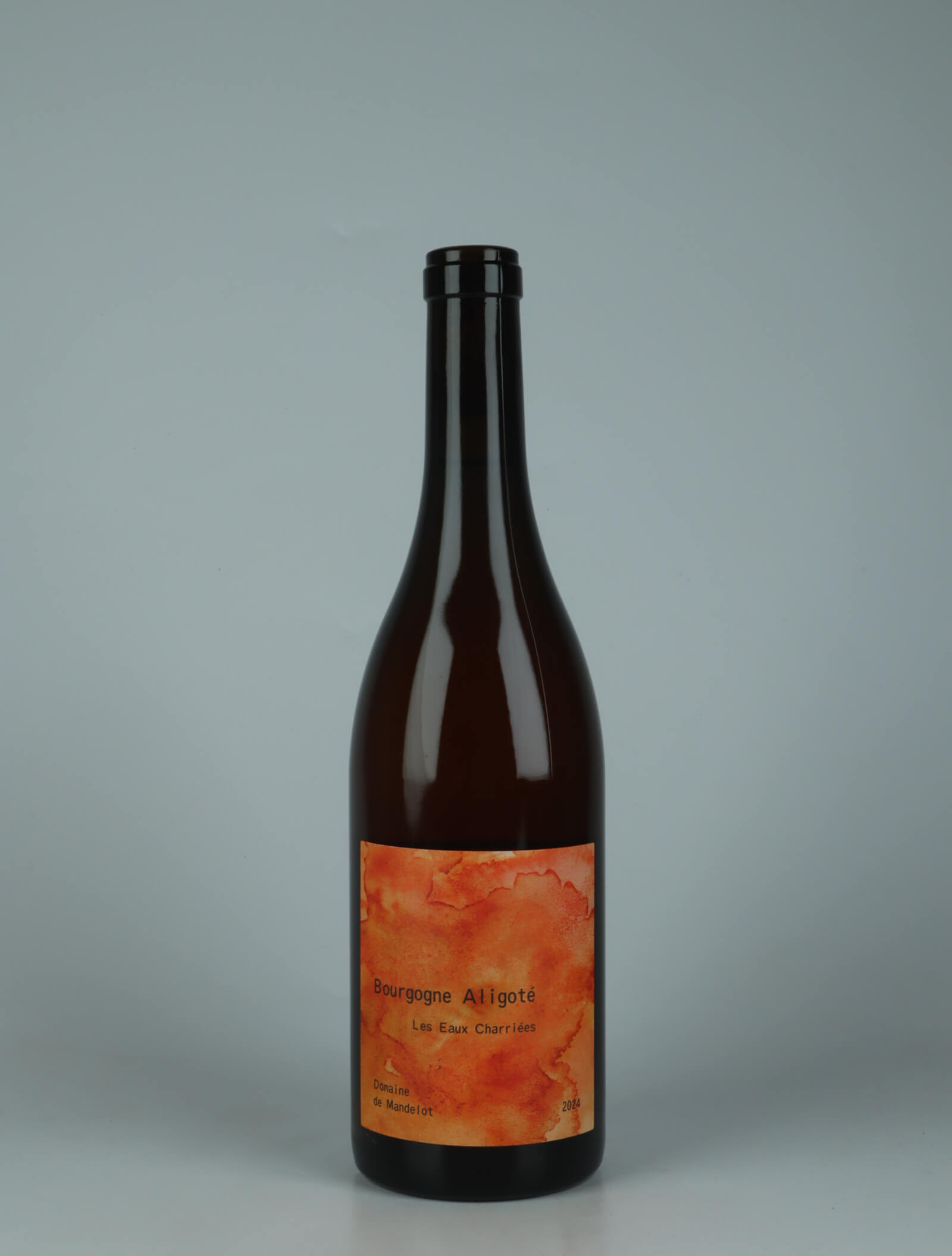 A bottle 2024 Bourgogne Aligoté - Macération - Les Eaux Charriées Orange wine from Domaine de Mandelot, Burgundy in France